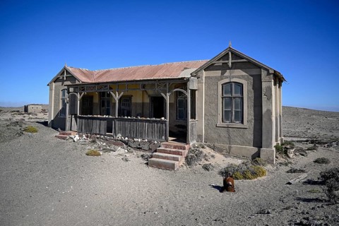 Dilapidated building in the desert sand, Pomona, restricted diamond area, near Lüderitz, Karas