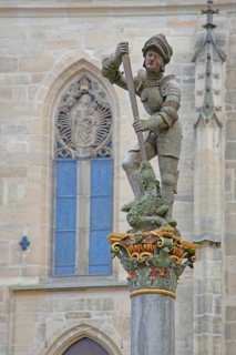 Sculpture of St George with stabbing weapon fighting dragons at St George's Fountain, detail,
