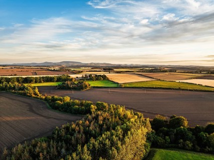 Sunset of Farms and Fields over Norham Castle from a drone, Norham, River Tweed, Northumberland,