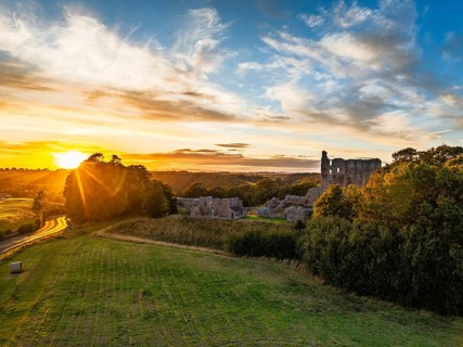 Sunset over Norham Castle and River Tweed from a drone, Norham, Northumberland, England, United