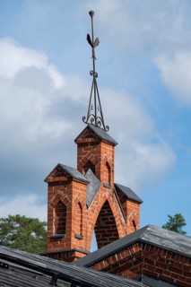 Iron ornamental element on roof peak, brick gable, former paper mill for the production of