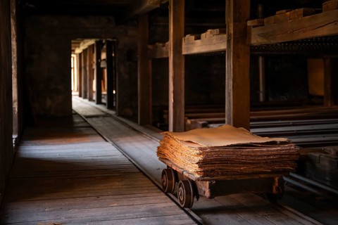 Wagon on rails for transporting cardboard, former paper factory and mill for the production of