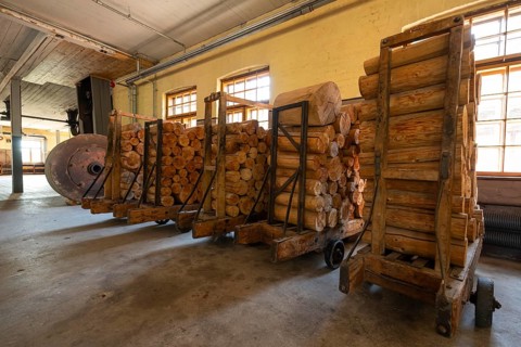 Carts with sawn logs for further processing, former paper factory and mill for the production of