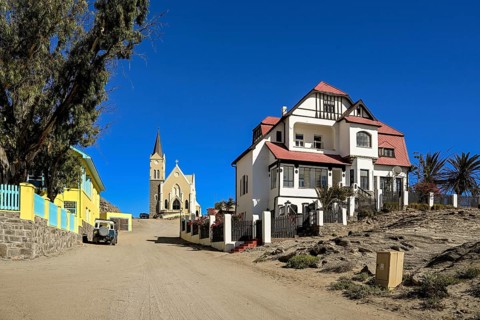 Colonial house facade in the Kirchstraße, in the background the rock church, Lüderitz, Karas