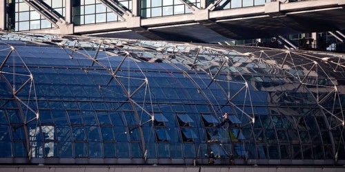 Three male glass cleaners cleaning a glass roof at Berlin Central Station, Berlin, Germany
