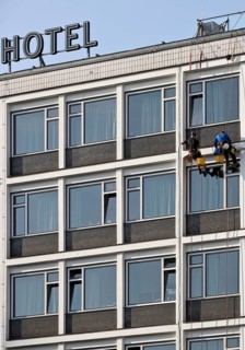Two male glass cleaners abseiling down the hotel façade to clean windows, aletto Hotel Kudamm,