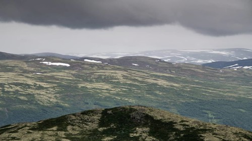 Vast mountain landscape with patches of snow and a cloudy atmosphere, pilgrimage route Olavsweg or