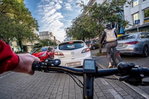 Cycling in the city, city centre road, cycle lane, two-wheeled traffic has priority, 30 km/h zone,