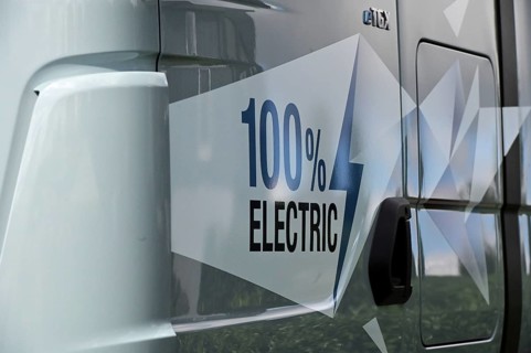 A sign on an electric lorry states that the vehicle is 100 percent electrically powered. The