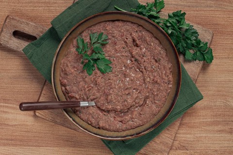 Red bean lobio, a traditional Georgian dish, on a wooden table, homemade