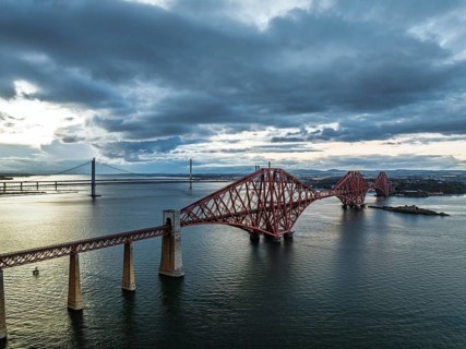 Rain clouds over Forth Bridge from a drone, Queensferry Crossing, Forth Estuary, Scotland, United