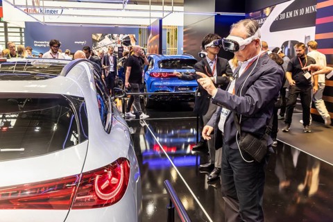 Mercedes trade fair stand with virtual presentation. Trade fair visitors with 3D glasses. The