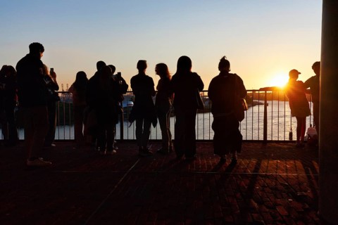 Crowd enjoying the view from the Elbphilharmonie over the Elbe at sunset, silhouettes, Plaza