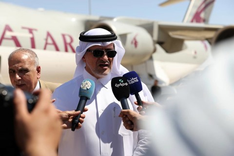 Officials from the Qatari and Syrian Red Crescents receive a Qatari airlift of aid to help the