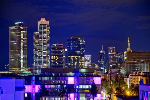 Rooftop day with colourfully illuminated houses for a techno party on the roof with a view of the