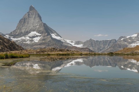 A stunning view of the Matterhorn mountain towering in the background, reflecting perfectly in a