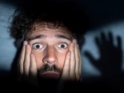 A close-up of a man whose face is marked by fear, symbolising anxiety disorders, panic attacks,