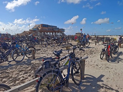 Car park for bicycles on the North Sea beach, Pfahlbau Strandbar 54° Nord, summer, sun, sand, on