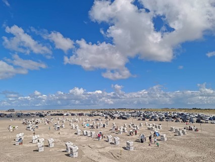 North Sea beach, car park, blue sky, white clouds, summer, sun, sand, beach chairs, on the edge of