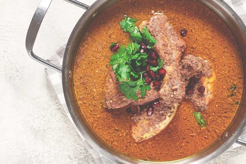 Fesenjan, an Iranian dish, stewed chicken, in a nut-pomegranate sauce, in a saucepan, light