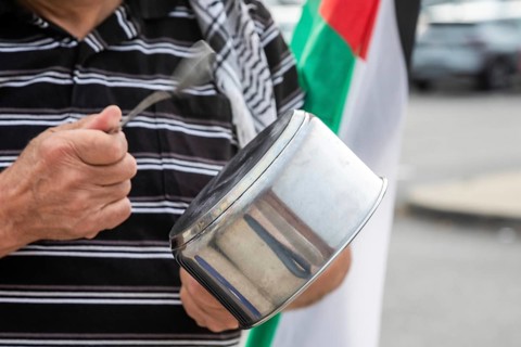 Detroit, Michigan USA - 23 August 2025 - Protesters rally at Eastern Market, banging empty pots to