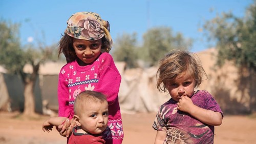 Syrian children playing in a refugee camp near the Turkish border on World Children's Day. Aleppo,