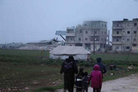Civil defense teams attempt to rescue civilians trapped under the rubble after a powerful