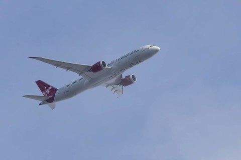Boeing 787 Dreamliner jet passenger aircraft of Virgin Atlantic airlines in flight in a blue sky,