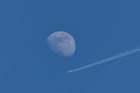 Boeing 737 jet passenger aircraft of Norweign Air with a vapour trial or contrail behind flying in