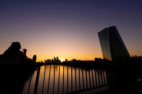 The sun sets behind the European Central Bank (ECB) and the Frankfurt banking skyline, Frankfurt am