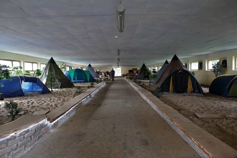 Indoor campsite in a former cattle shed at Fleether Mühle, Müritz National Park,
