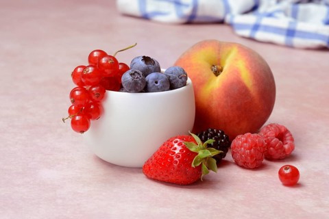 Various fruits in peel, redcurrant, peach, strawberry, blueberry, blackberry, raspberry