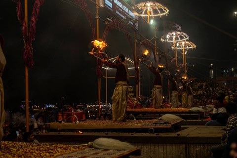 Hindu priest performing the Aarti ritual, holding a burning oil lamp, at the Ganges, Bangali Tola,