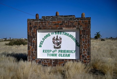 Sign with town coat of arms at the entrance to Keetmanshoop, Karas Region, Namibia