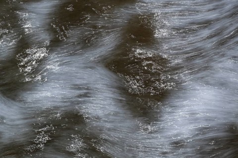 Close-up of moving water with a pattern of light and shadow, long exposure, North Sea, Denmark