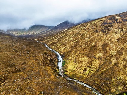 Eas a' Bhradain Waterfall from drone, Red Cuillin mountains, Loch Ainort, Isle of Skye, Scotland,
