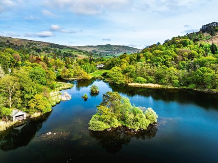 Farms and Mountains over road A591 from a drone, Grasmere Lake, Grasmere, Ambleside, Lake District,