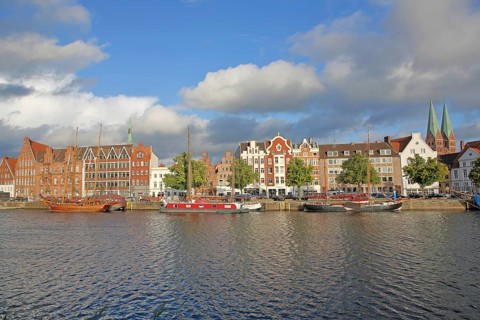 Ships on the banks of the Stadttrave, houses, cityscape, sailing ship, quay, harbour, steeples of