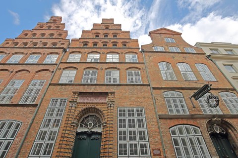 Historic Schabbelhaus built in the 18th century with stepped gable, brick building, nose sign,