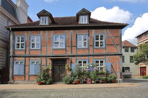Half-timbered house and brick building, decoration with planters, Schelfstadt, Schwerin,