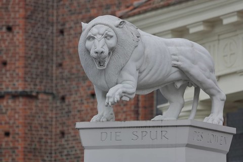 White Lion Monument by Peter Lenk 1996 with inscription Die Spur des Löwen and monument to the city