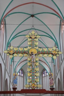 Gothic golden triumphal cross from 1420 with church patron Saint John the Apostle and Mary in the