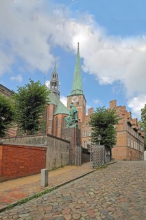 Monument to writer and poet Emanuel Geibel by Hermann Volz 1889 and St Jakobi Church, brick church,