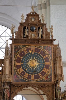 Rood screen with Gothic clock built in 1477 with decorations and figures, interior view, church