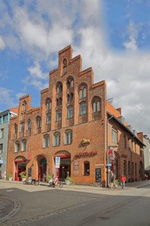 Historic lion pharmacy with stepped gable, brick building, pedestrian, pharmacy, old town, Lübeck,