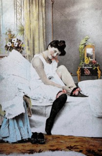 Female nude from around 1899, erotic postcard, playgirl, woman putting on stockings in the bedroom,