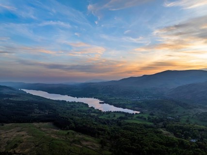 Sunset over Mountains and Coniston Water from drone, Lake District National Park, Cumbria, England,