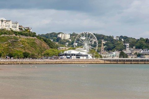 View to Princess Theatre and Ferris Wheel, Torre Abbey Sands sandy beach, Torquay, Devon, England,