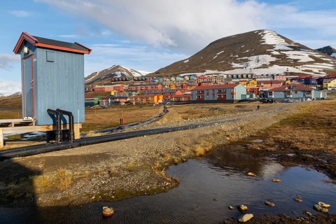 Colourful houses with exposed supply lines, Longyearbyen, Spitsbergen, Svalbard