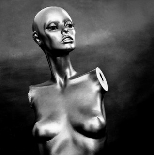 A reflective mannequin stands in a striking pose within a studio, highlighting its elegant features